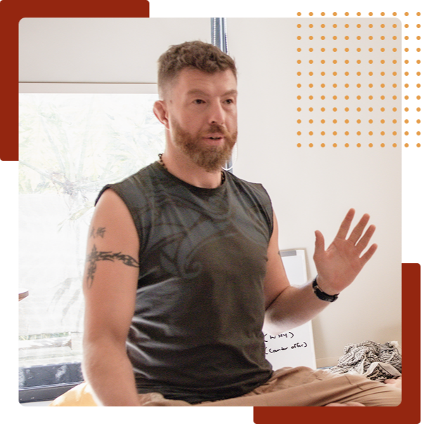 Ricky speaking and gesturing with his hand during an in-person workshop or coaching session in a bright room