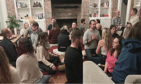 Ricky speaking and gesturing with his hand during an in-person workshop or coaching session in a bright room