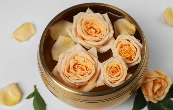 A woman smiles, closes her eyes and puts her arms out 