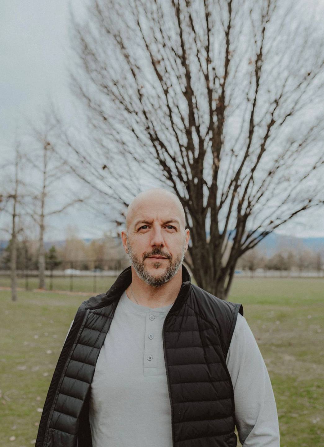 Kevin McNee standing outdoors in front of a tree