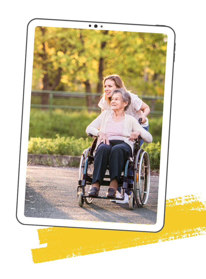 A group of six people sits on the ground outdoors under a blue sky, with mountains in the distance, embracing nature connection. Some wear hats and sunglasses.