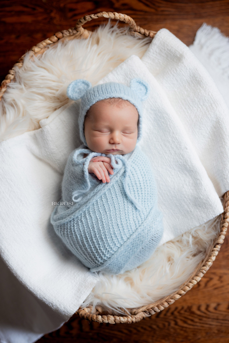newborn baby sleeping in a basket