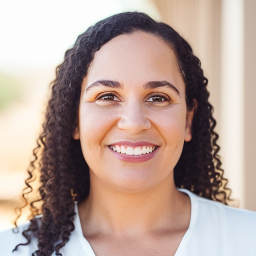 Photo of smiling friendly black woman in a white shirt