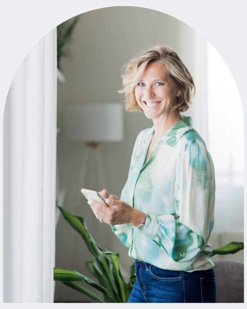 Ciara Stockeland looking at camera while holding mobile phone