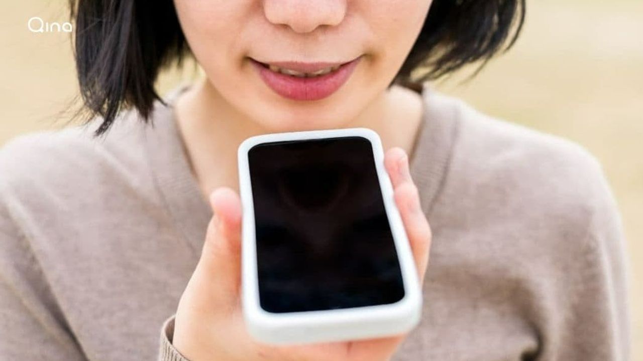 Person talking into smartphone