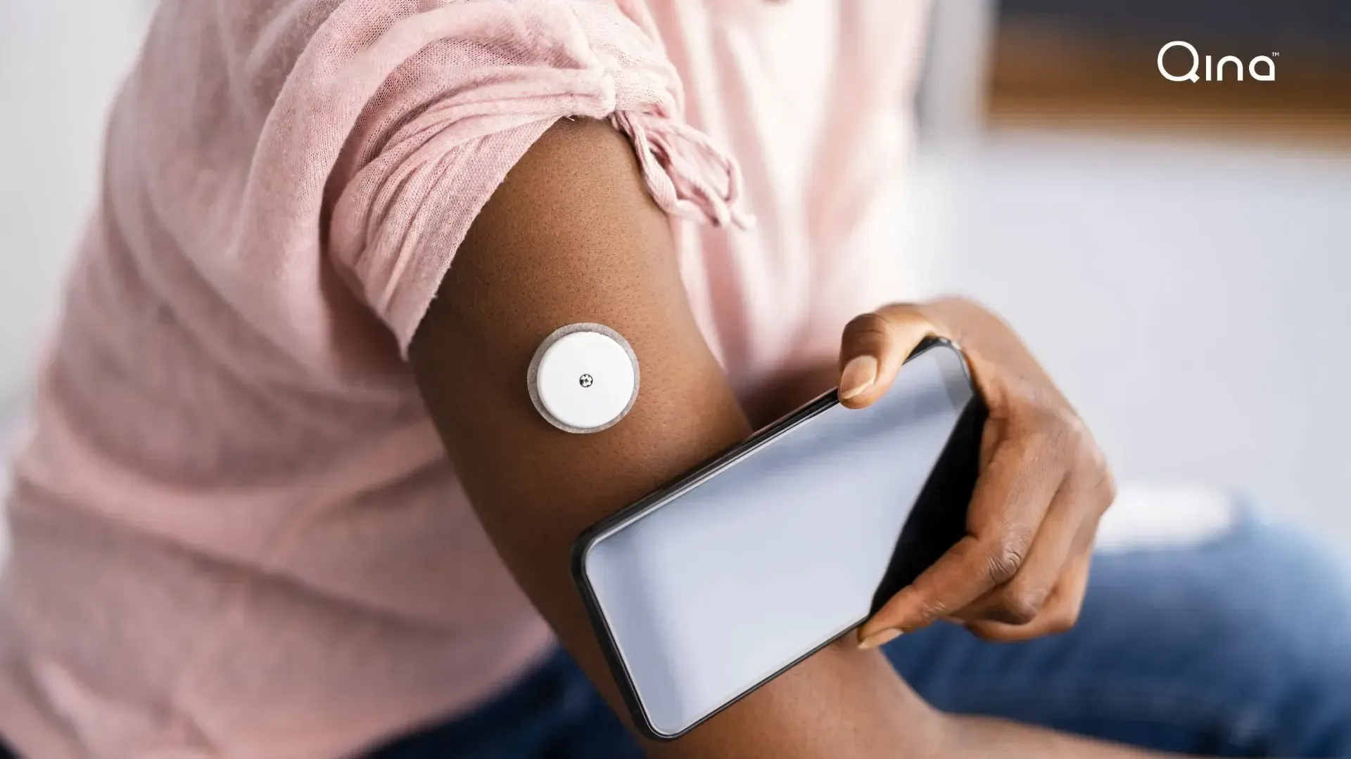 Woman scanning CGM with smartphone