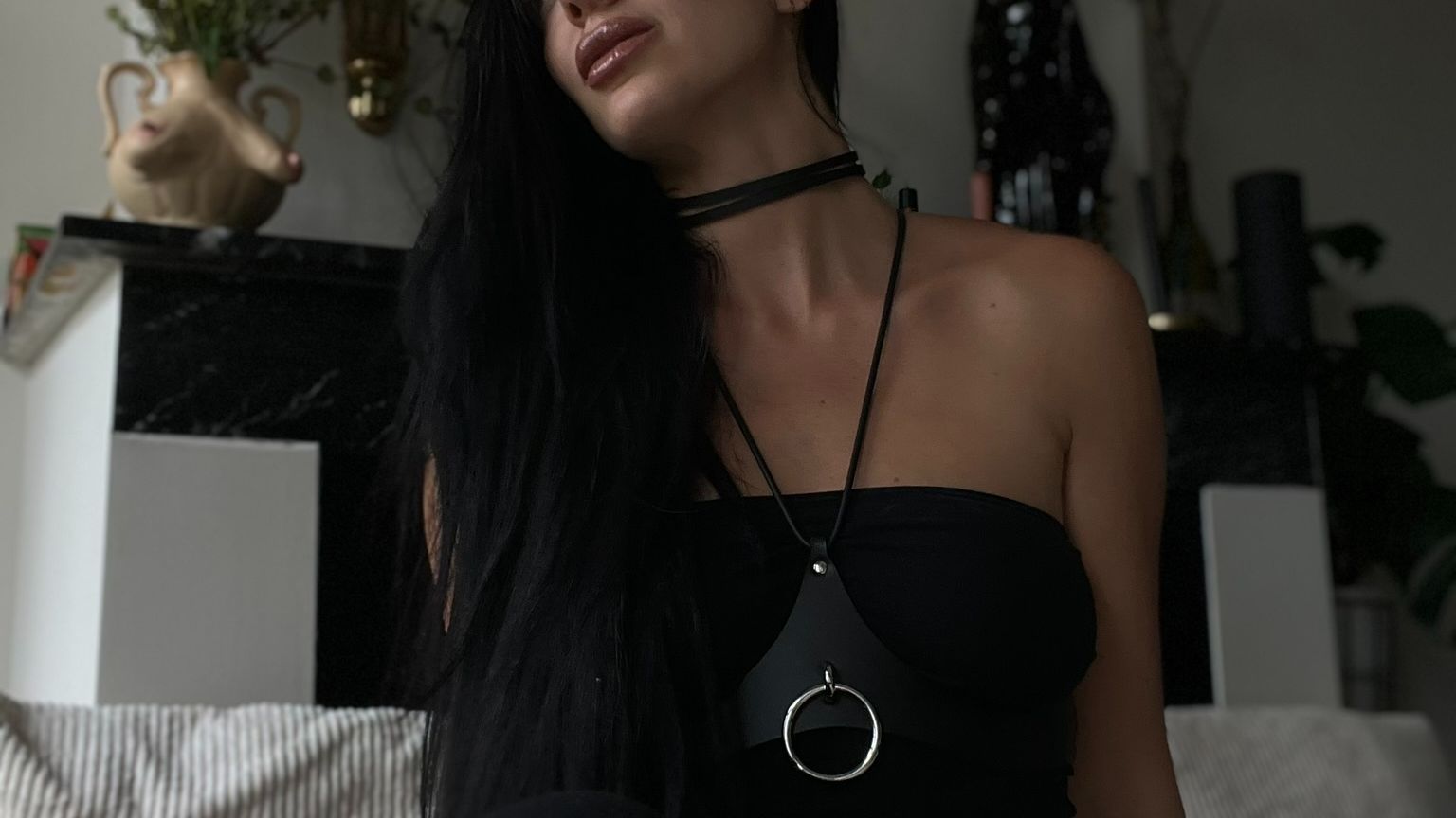 Julieta wearing black leather looking into distance