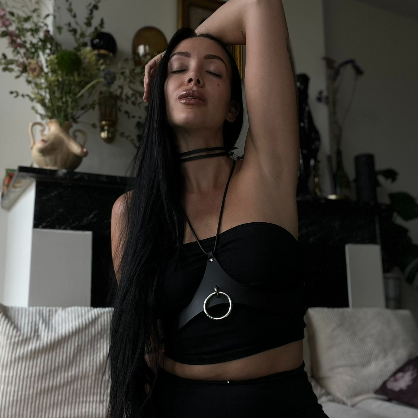 Julieta Chiara's head tilted with arm behind her head wearing black leather