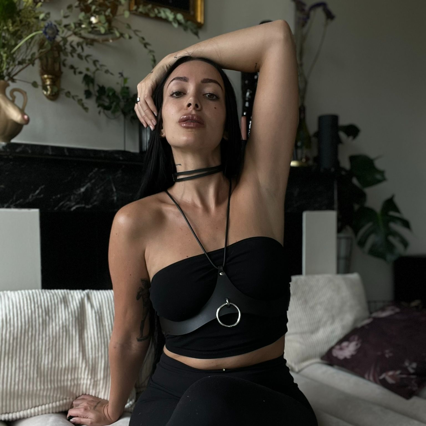 juileta in leather with arm above her head posing