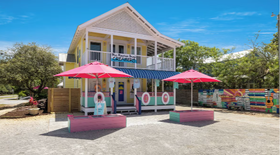 Alli Worthington smiles with open laptop, teaching how to build your own course