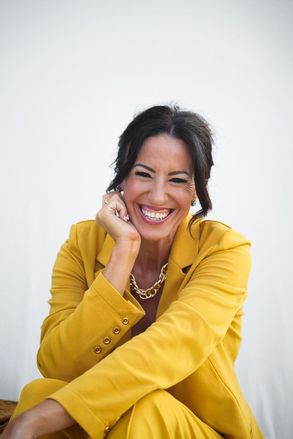 Woman in yellowcsuit smiling