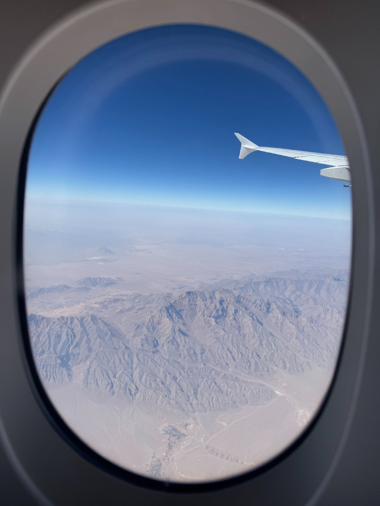 Footer Logo - Airplane Window. Seeing Artic outside north pole - jet wing. 