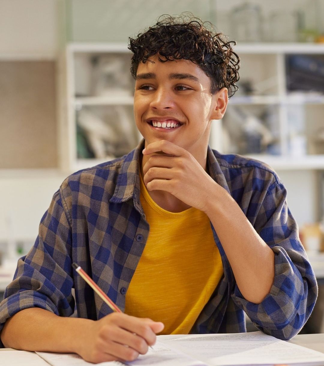 A student sitting at a desk with a notebook and pencil, pausing to think before writing, illustrating a learning moment where reflection and understanding matter more than rushing through content.