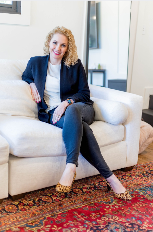 Alli Worthington smiles with open laptop, teaching how to build your own course