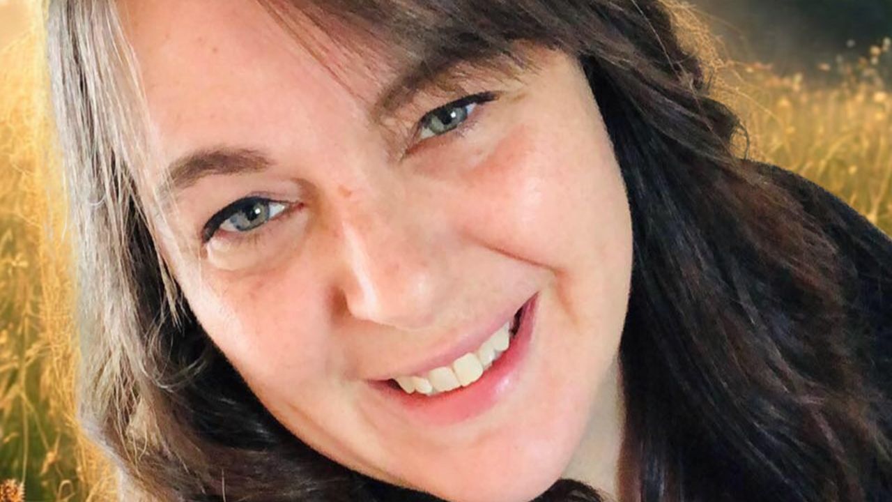 Portrait joyeux et serein de Julie Bélanger, symbolisant la clarté intérieure et la compréhension des mécanismes biologiques (Coaching avec MANIC.)