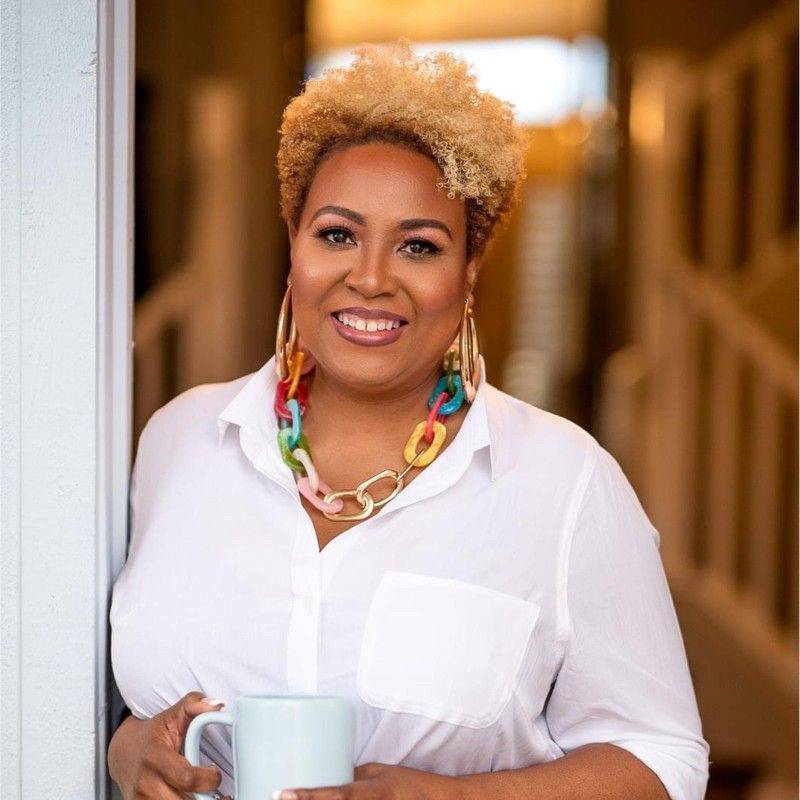 Dr. Nadia Y. Brown in white blouse with brightly colored necklace