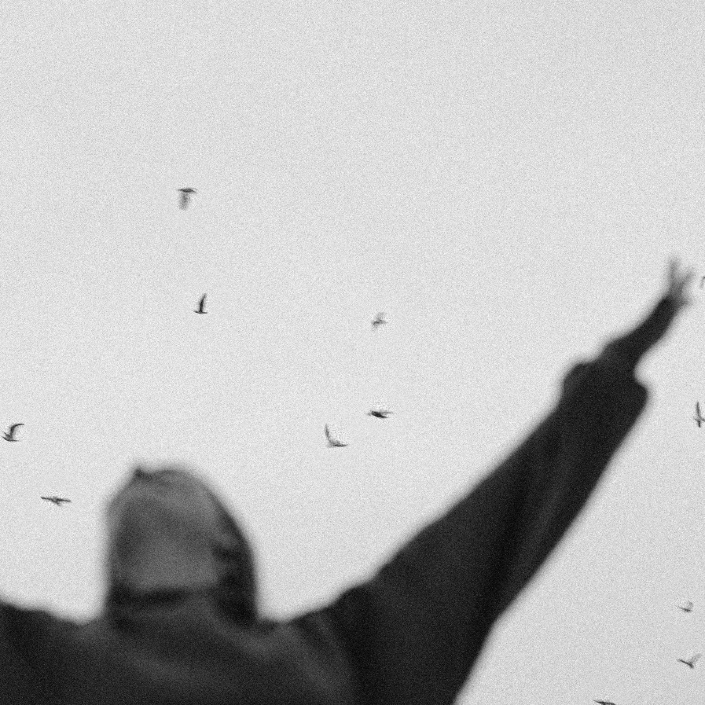 Woman standing outside with arms raised toward the sky, expressing a sense of physical freedom and ease.