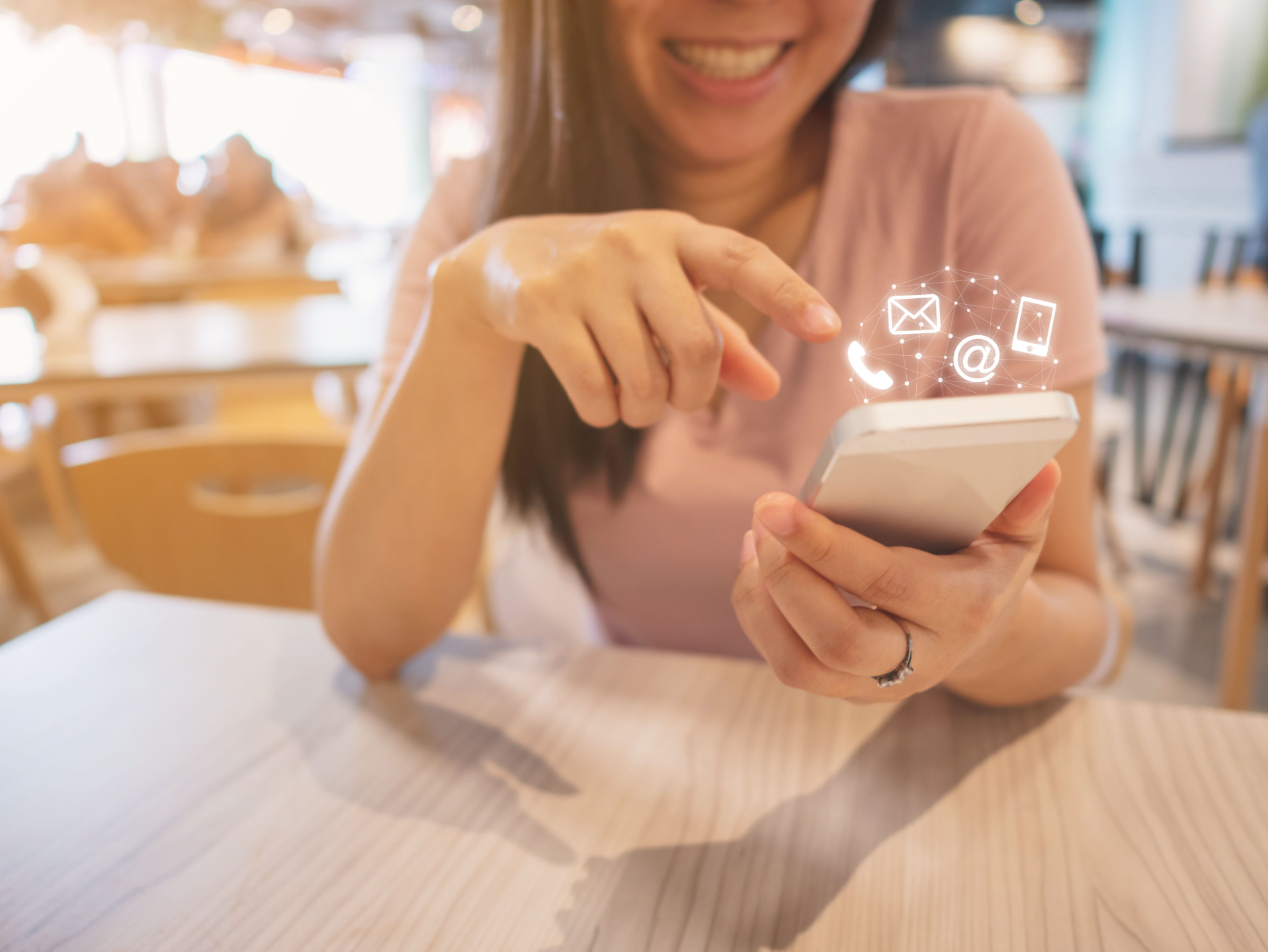 Woman using smartphone to contact customer support for coaching insurance and professional association membership assistance.