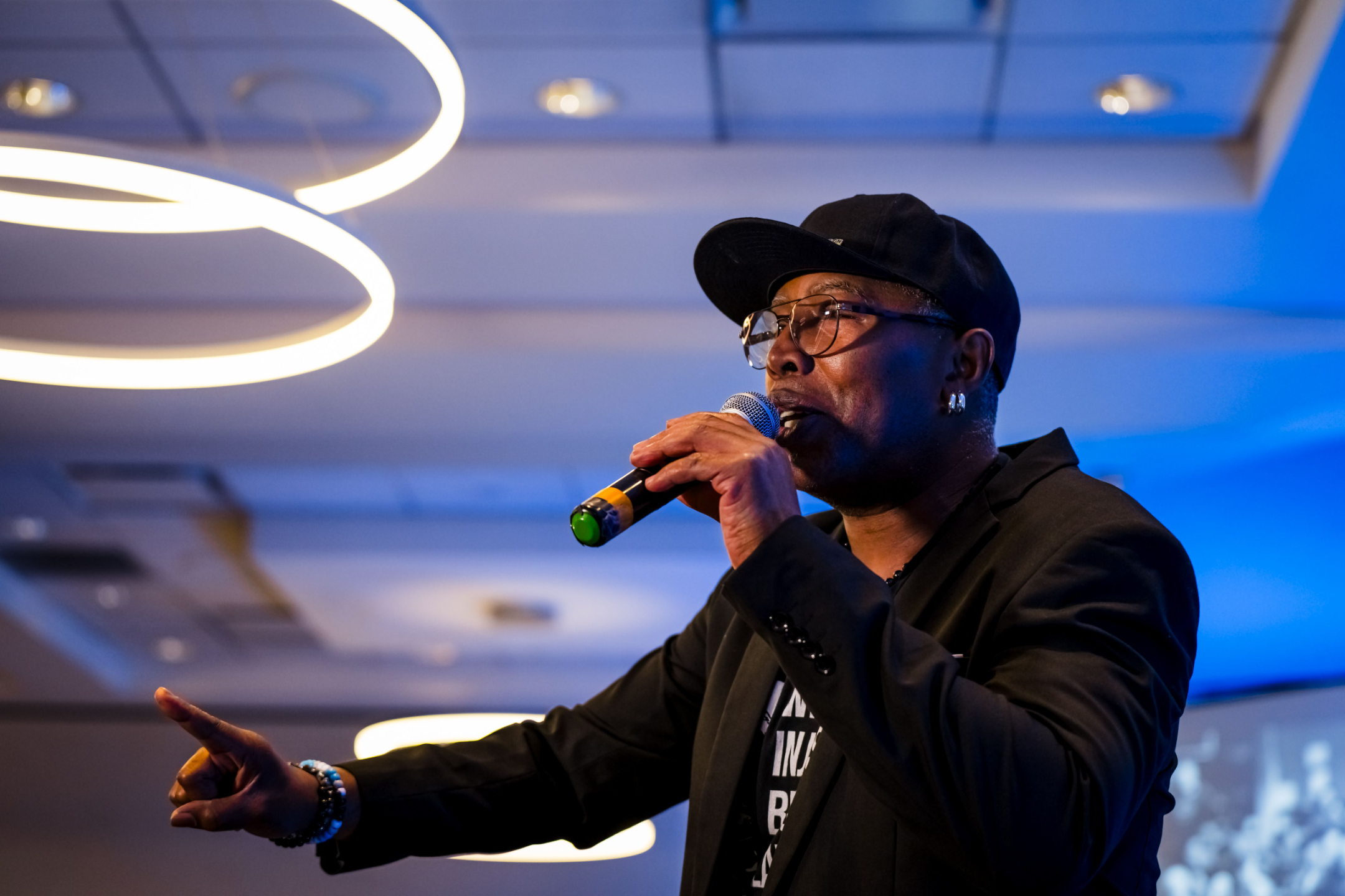 Kaitlin and Tommy sit on a stoop, wearing Black clothes and gazing at the camera.