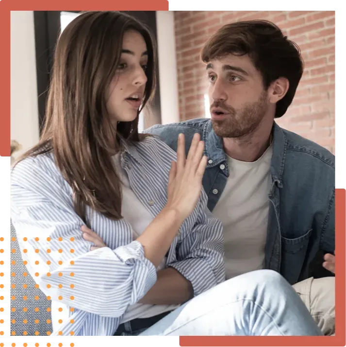 A young couple having a serious conversation during a relationship conflict in a modern indoor setting