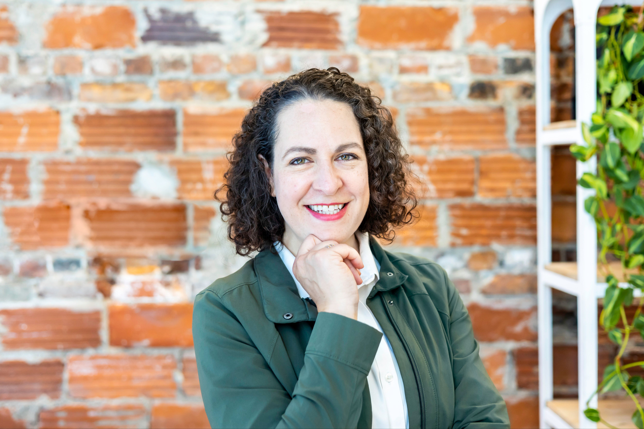 Erica gestures as she meets with a coaching client