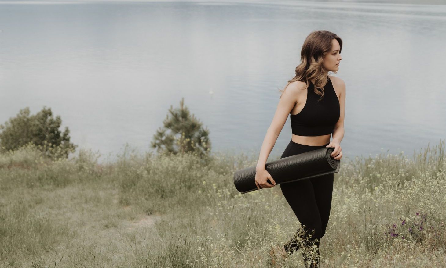 woman getting ready to do yoga lakeside