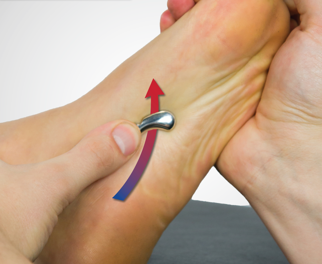 IASTM tool treating the quadratus plantae of the foot