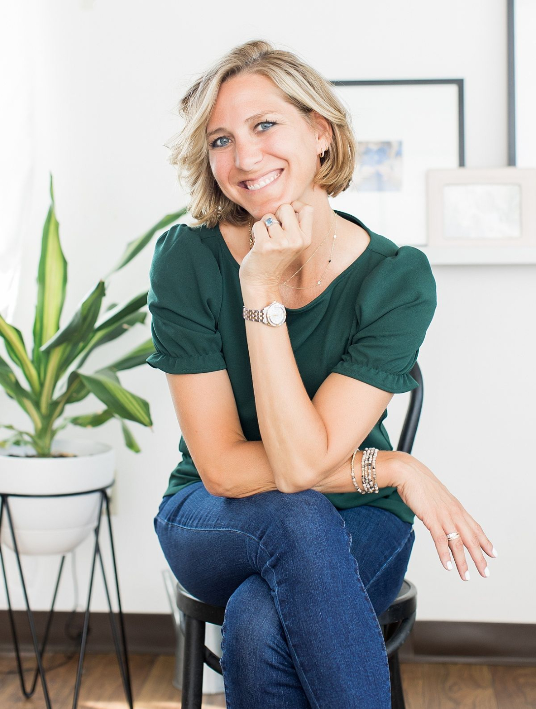 Ciara Stockeland, founder of Inventory Genius®, sitting in a chair and looking at the camera with hand under her chin..