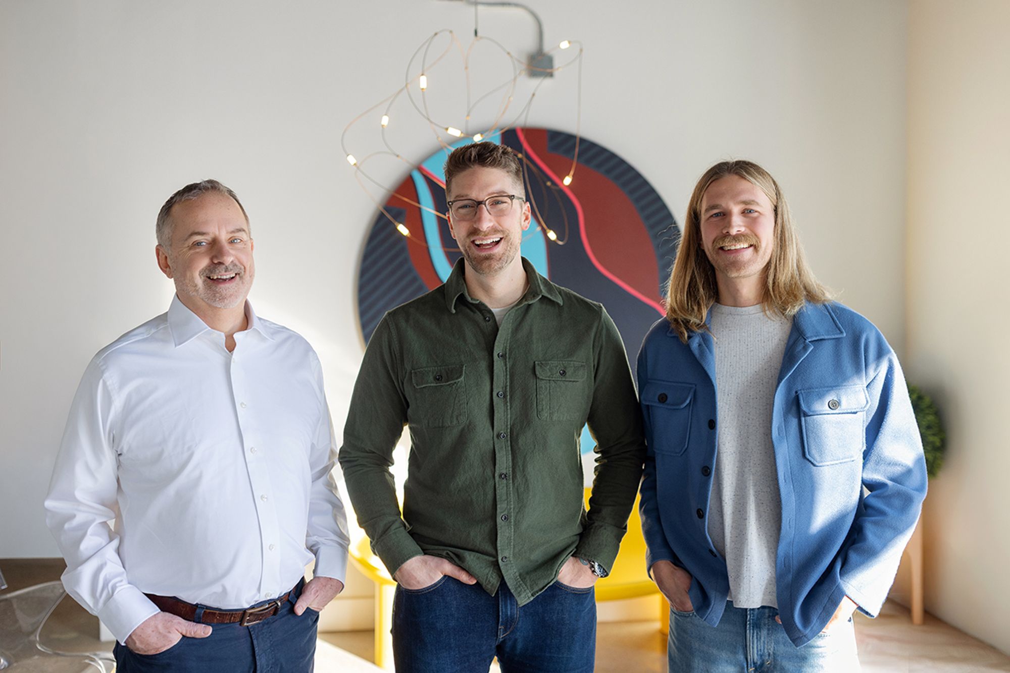 Metro-Detroit Men's Therapy therapists Robert Blender, Mike Lamerato, and Stephen Busscher standing together in their Metro-Detroit office