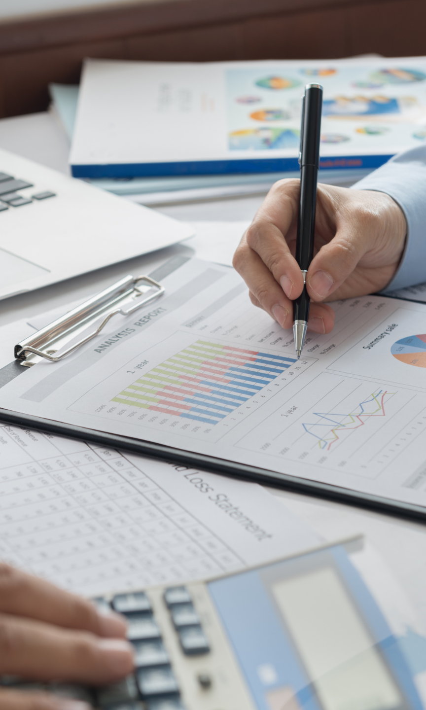 Two professionals analysing data on a desk