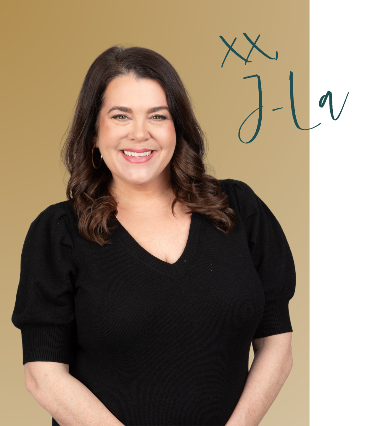 Justine Lackey Sitting at a Desk on her Computer with Brick Wall Behind her