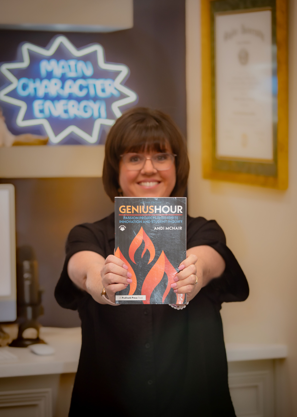 andi mcnair holding book genius hour with main character energy in background