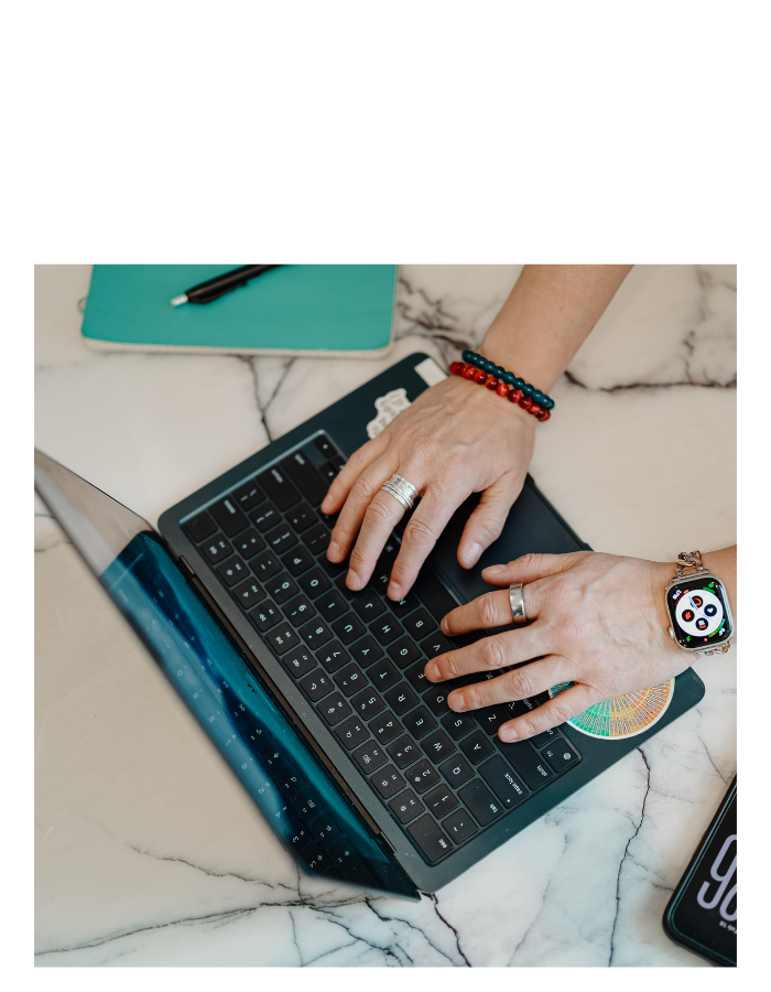 Hands on laptop, scripted "Newsletter" above.