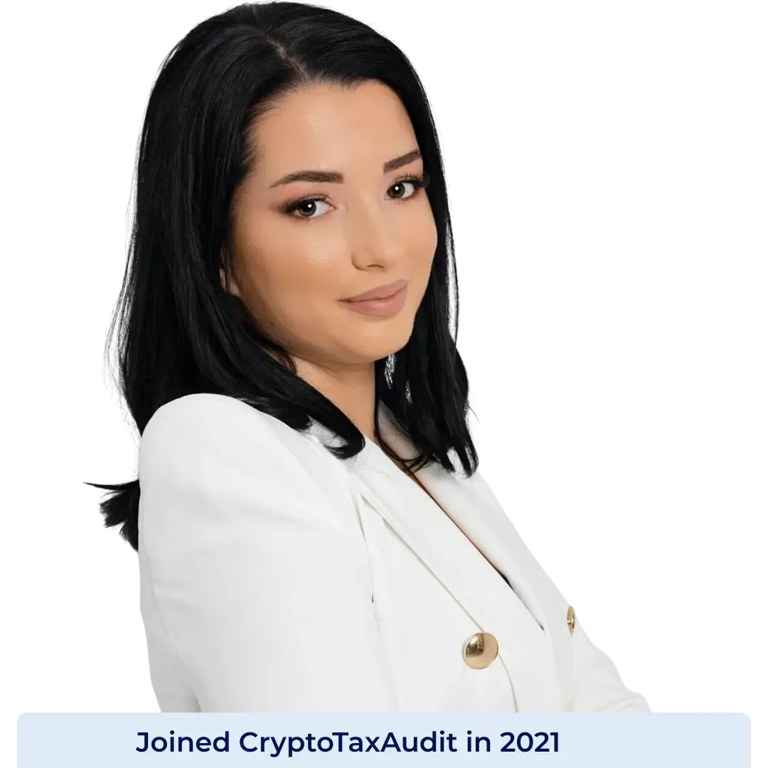 Portrait of Ira Sogani, Senior Crypto Analyst and Enrolled Agent at CryptoTaxAudit, wearing a white blazer and standing with her arms crossed against a white background.