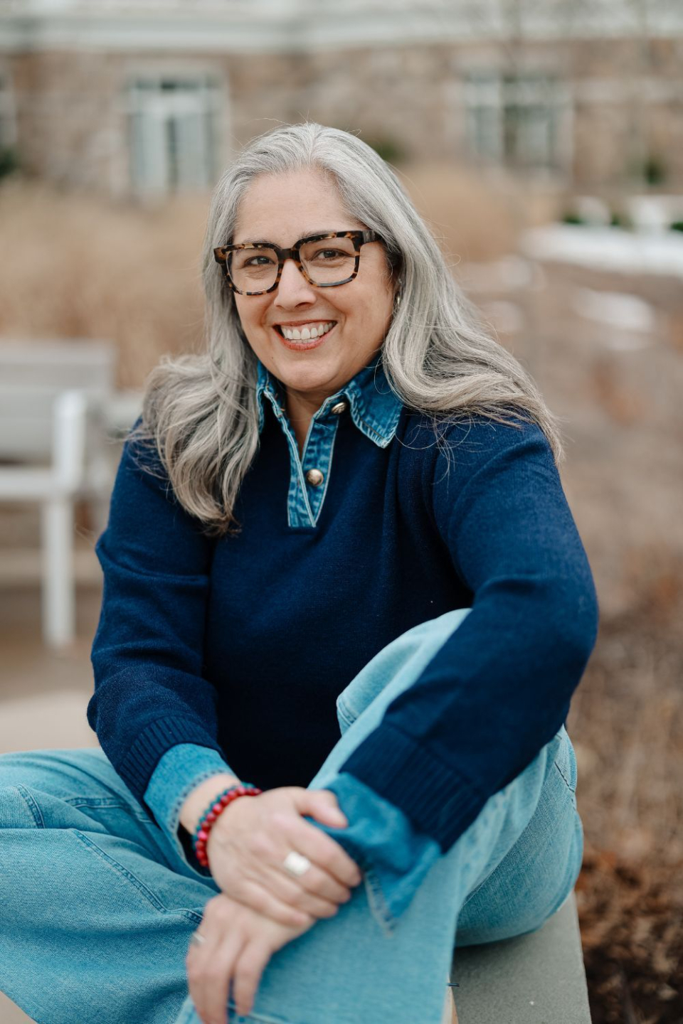 Danielle in casual clothes facing camera smiling