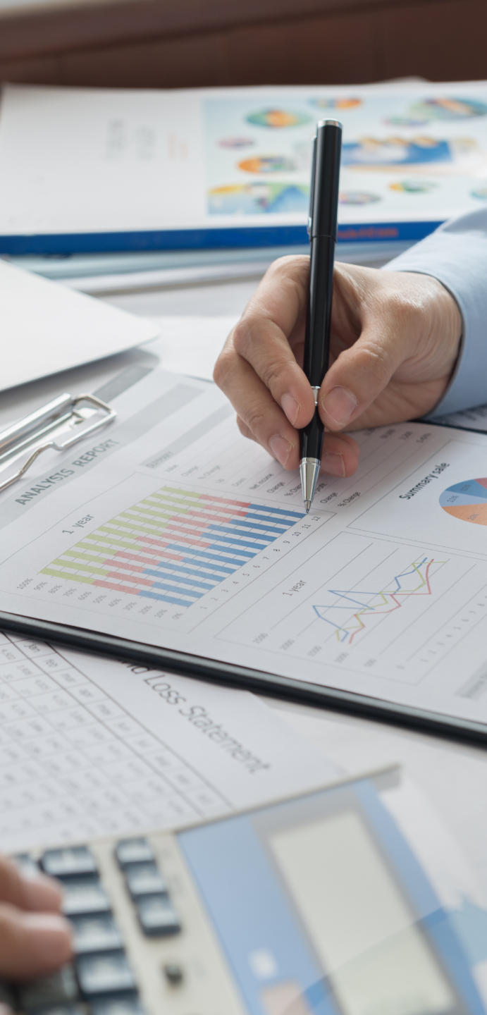 Two professionals analysing data on a desk