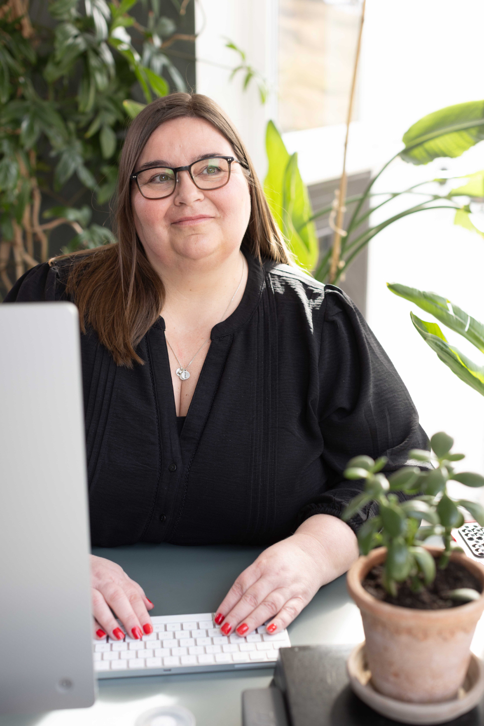 Astrid Valen-Utvik sitter ved pc og jobber med medlemskapet VU Kompetanse Pluss