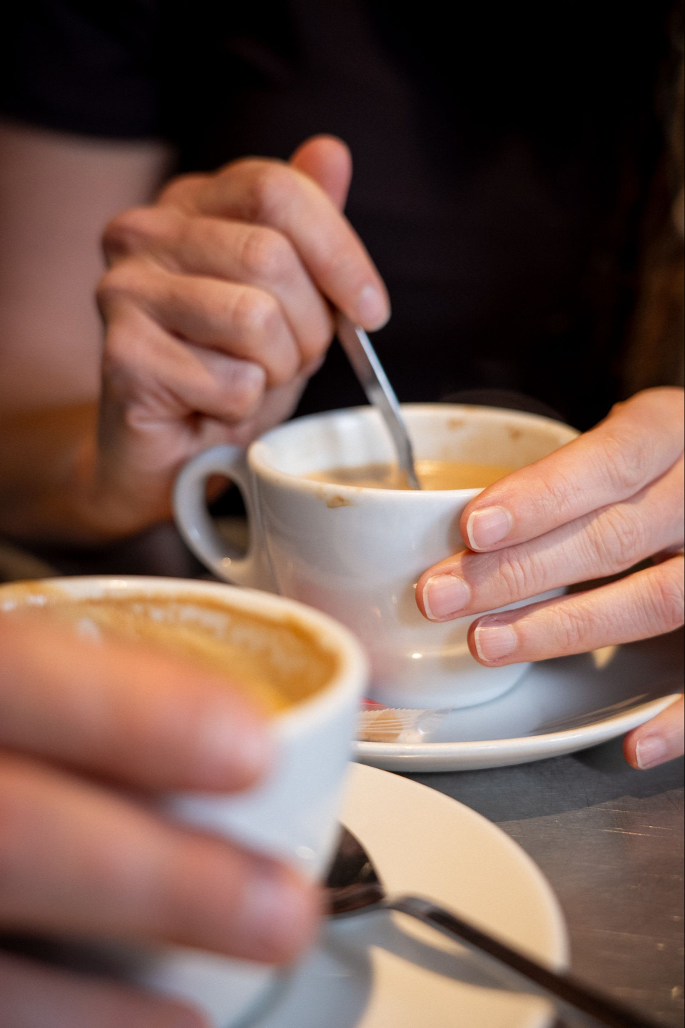 Two people in a one-to-one mentoring conversation over coffee