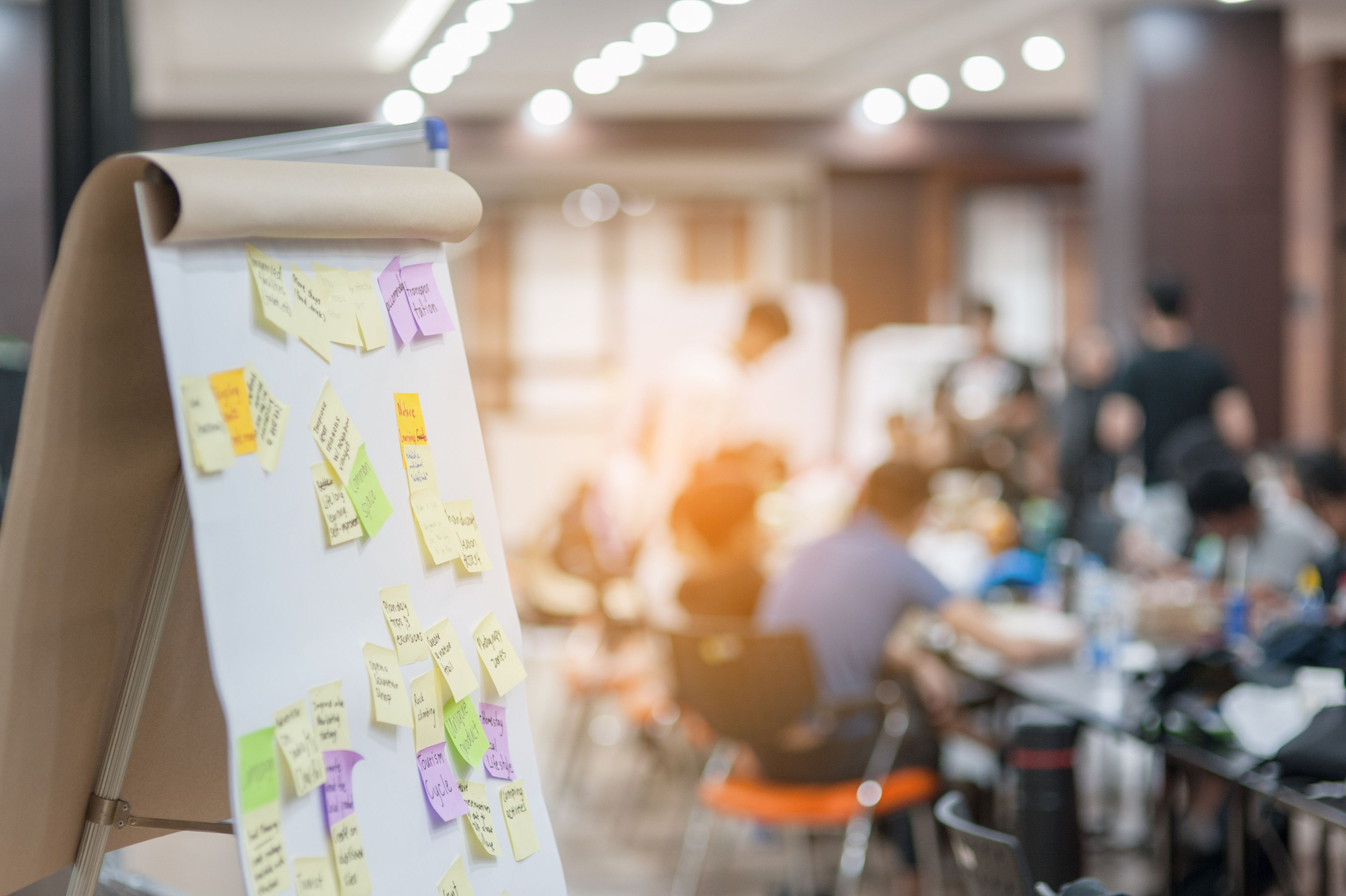 A leadership team working together at a whiteboard
