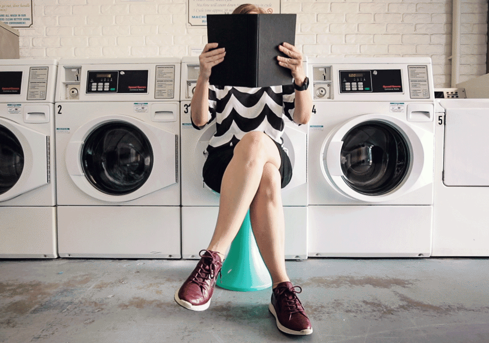 A photograph of a finger bursting a bubble in crisp detail