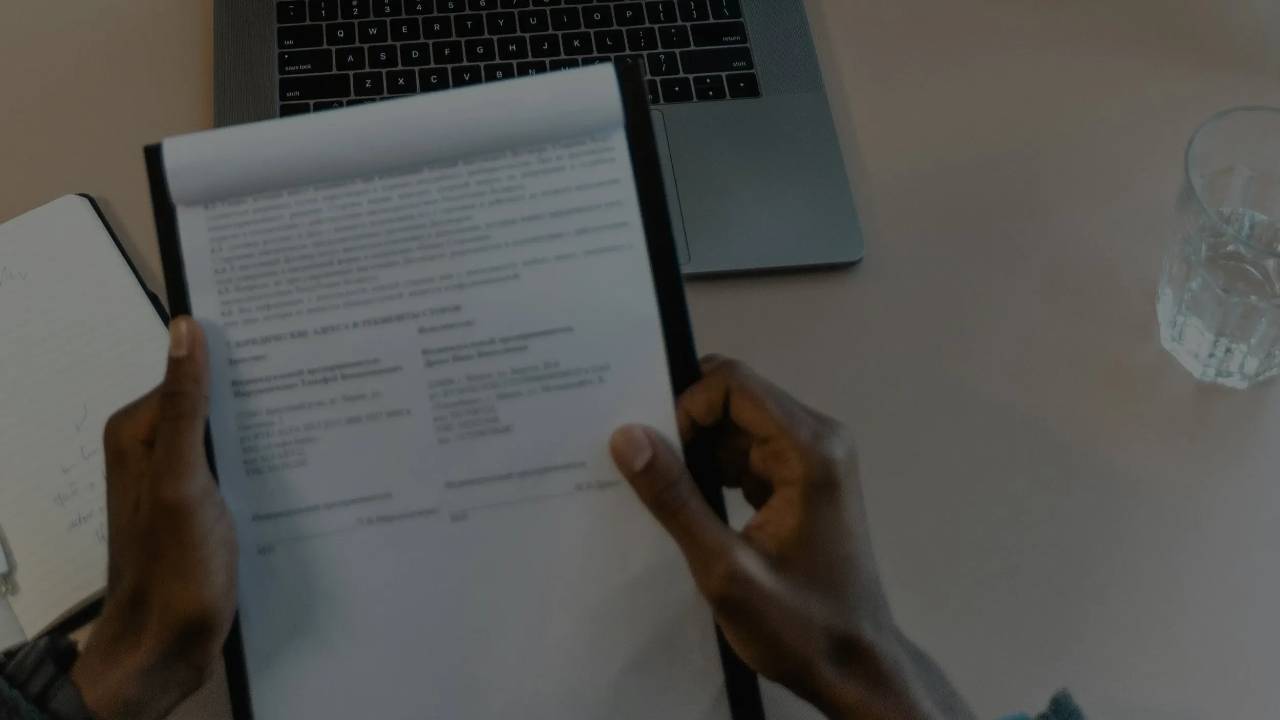 Picture of clipboard with notes in hands