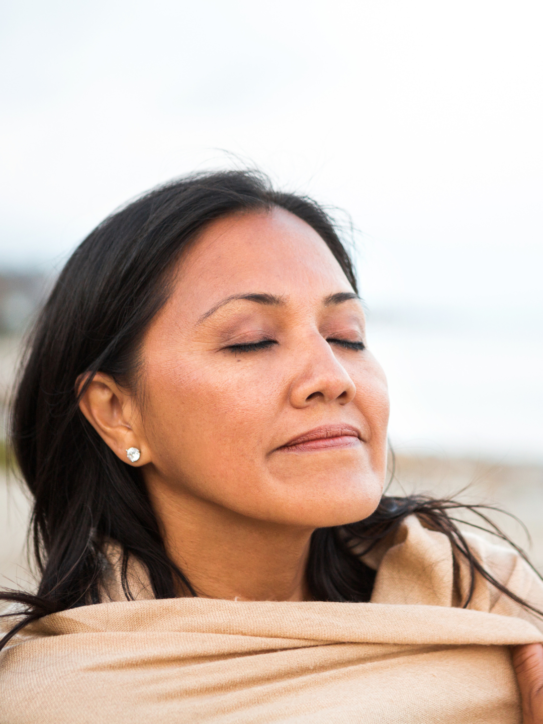 A woman breathing calmly with her eyes closed