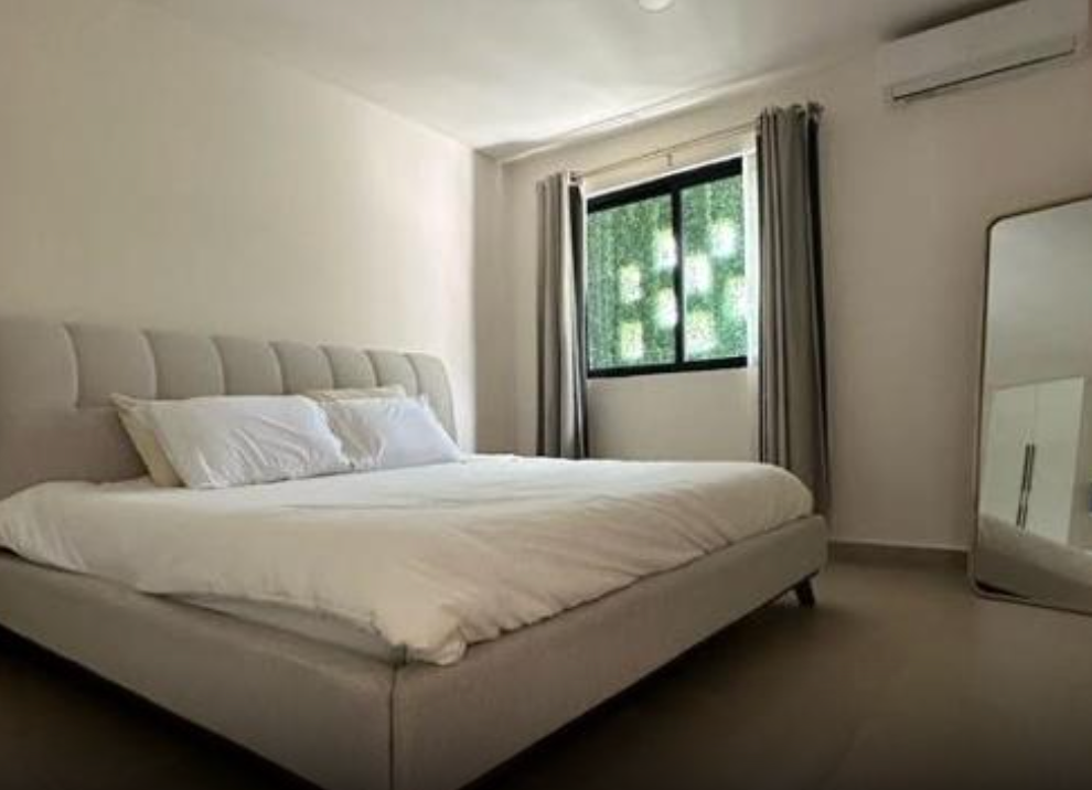 Bedroom with queen sized bed and window