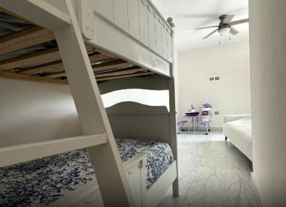 Bedroom with bunk beds and comfy looking pull out couch