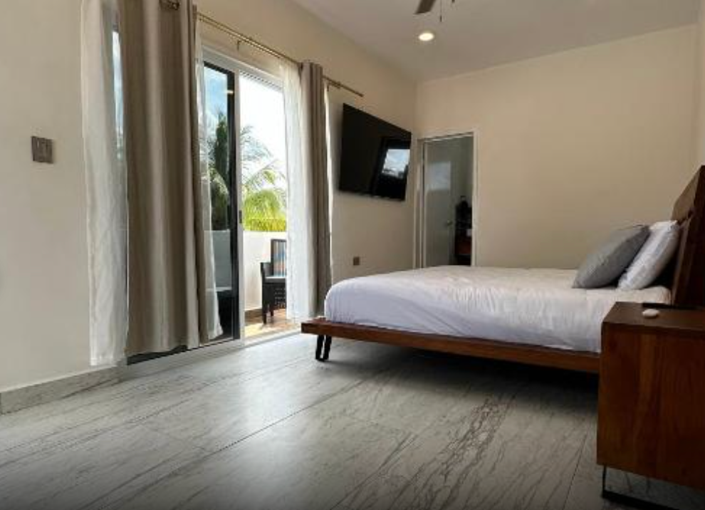 Bedroom with Queen sized bed and sliding door to deck