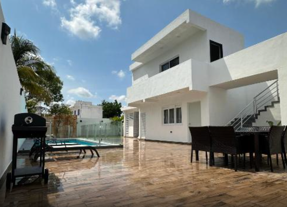 outdoor pool on beautiful deck with a table to the side