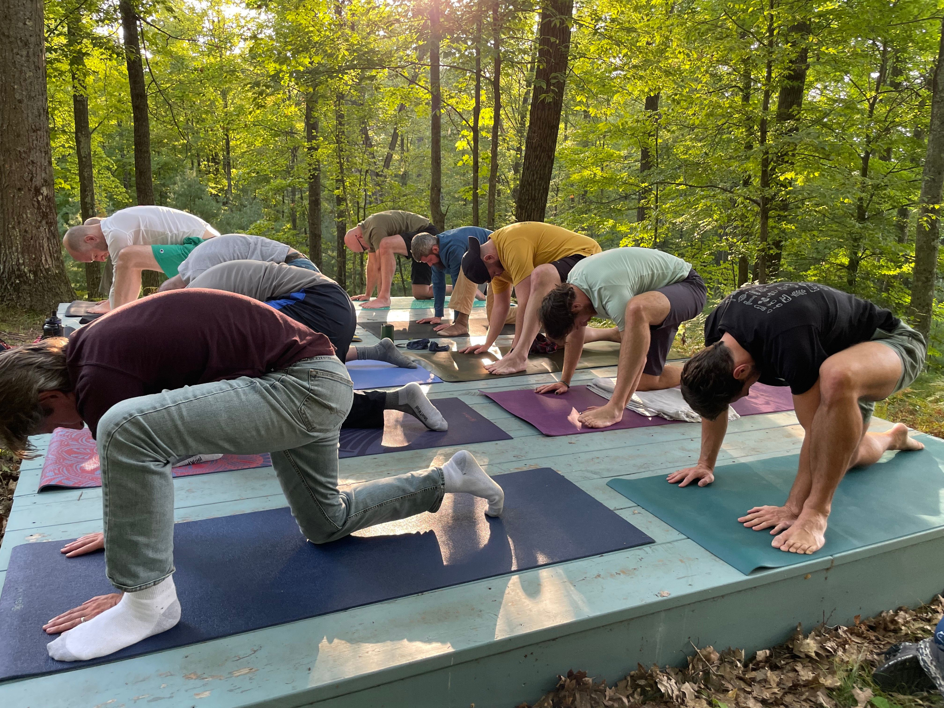 A glowing tipi at night under a green sky at Lynx Run Wilderness during the Annual Men's Retreat in Michigan