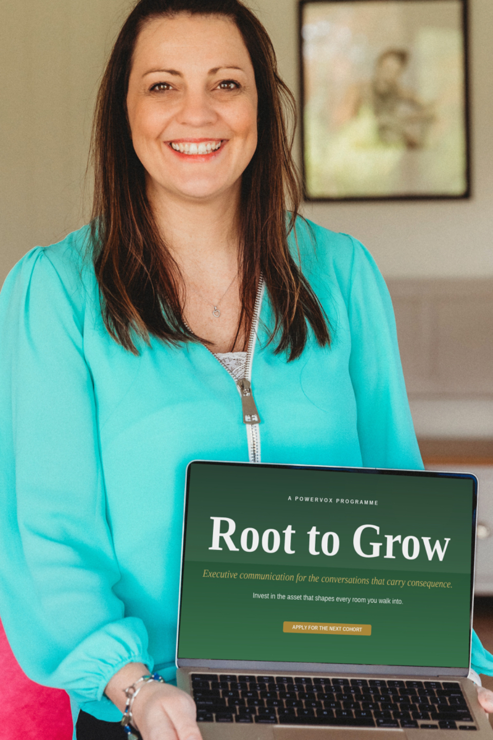 Rachel Flower, Founder of PowerVox, holding a laptop displaying the Root to Grow landing page