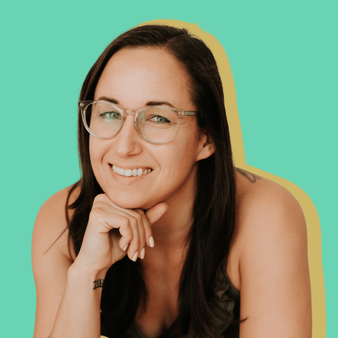 Kassy smiling at the camera while watching an online conference