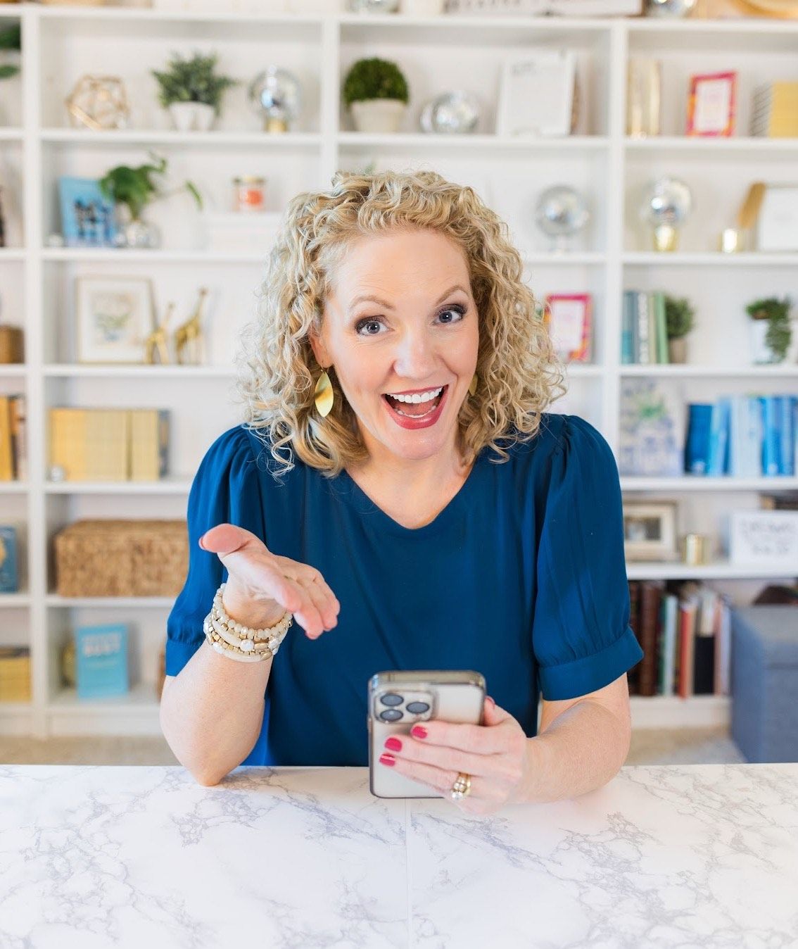 Alli Worthington smiles with open laptop, teaching how to build your own course